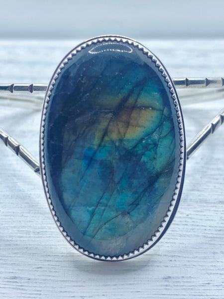  One of a kind handcrafted bracelet.  Sterling silver cuff bracelet set with a gorgeous natural green and blue labradorite stone.   Ships within 1 to 2 business days. (Not including weekends or holidays)  The Labradorite encourages you to go after your dreams, and helps you get out of your own way so you can make your dreams come true.