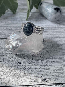 One of a kind handcrafted ring.  This beauty is a 3 band sterling silver ring set with a natural Spiderweb Obsidian stone. Beautiful grayish black stone looks so pretty up against bright silver setting. Available in a US size 8.  Ships within 1 to 2 business days. (Not including weekends or holidays)  Like its name, this stone has a spiderweb pattern. Nothing scary or creepy about this spiderweb. The spiderweb design is said to snare good luck without letting go. Yes please!! 