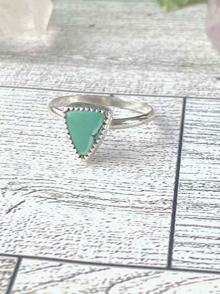 One of a kind handmade ring.  Beautifully handcrafted sterling silver ring set with a  natural, triangle shaped, gorgeous green turquoise stone- size 8   Delicate, smooth, sterling silver round band for an extremely comfortable fit.  Ships within 1 to 2 business days. (Not including weekends or holidays)  Turquoise, the captivating sea-green stone of the ancients, represents wisdom, tranquility, protection, good fortune, and hope. 