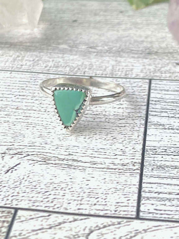 One of a kind handmade ring.  Beautifully handcrafted sterling silver ring set with a  natural, triangle shaped, gorgeous green turquoise stone- size 8   Delicate, smooth, sterling silver round band for an extremely comfortable fit.  Ships within 1 to 2 business days. (Not including weekends or holidays)  Turquoise, the captivating sea-green stone of the ancients, represents wisdom, tranquility, protection, good fortune, and hope. 